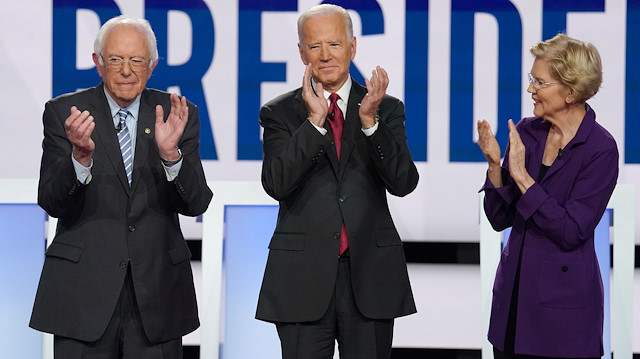 Senator Bernie Sanders applauds with former Vice President Joe Biden and Senator  Elizabeth Warren