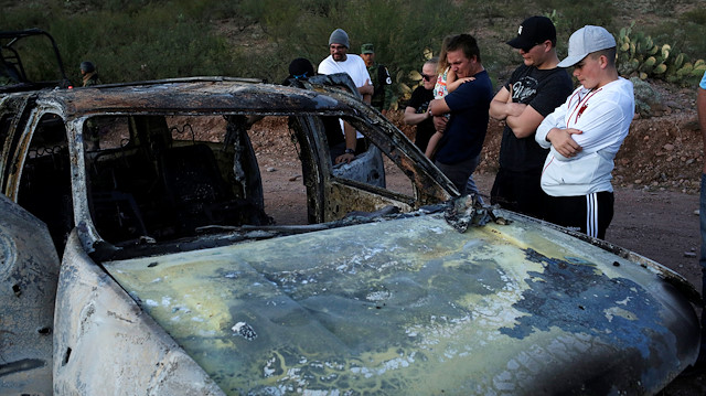 Relatives of slain members of Mexican-American families belonging to Mormon communities observe the burnt wreckage of a vehicle where some of their relatives died, in Bavispe, Sonora state, Mexico November 5, 2019. 