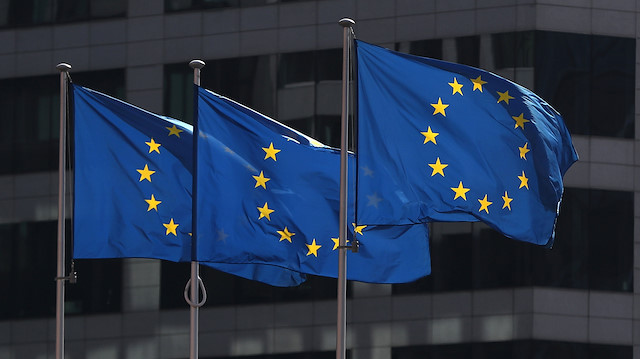 European Union flags fly outside the European Commission headquarters in Brussels.