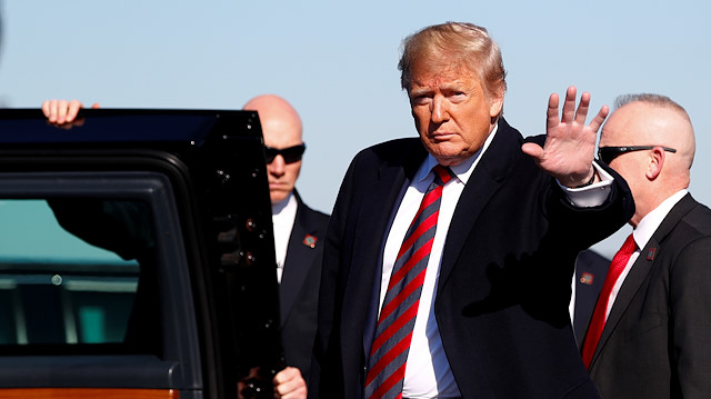 U.S. President Donald Trump waves to the press before entering "the beast" presidential limousine at Tuscaloosa Regional Airport in Tuscaloosa, Alabama, U.S., November 9, 2019