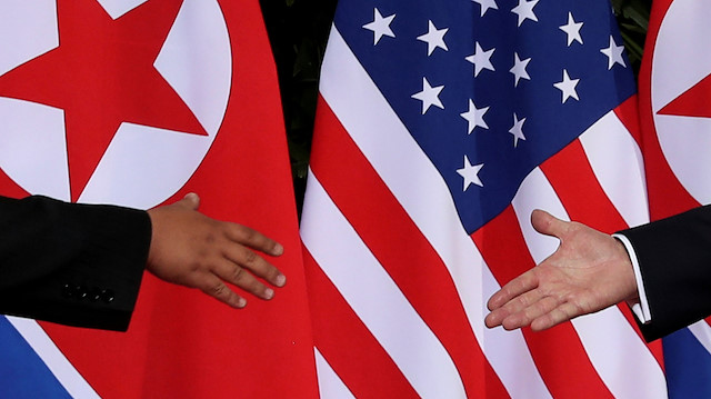 FILE PHOTO: U.S. President Donald Trump and North Korea's leader Kim Jong Un meet at the start of their summit at the Capella Hotel on the resort island of Sentosa, Singapore June 12, 2018.