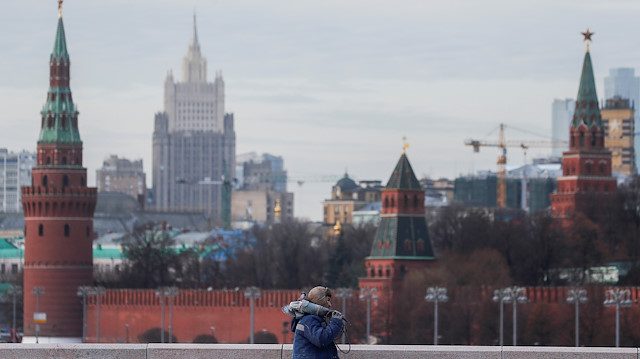 File photo: A construction worker walks along the bridge with Moscow's Kremlin in the background, in Moscow, Russia 