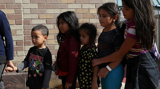 FILE PHOTO: Children form a line as undocumented immigrant families are released from detention at a bus depot in McAllen, Texas, U.S., June 22, 2018. 