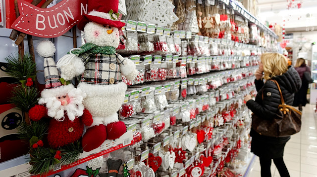 A woman looks at Christmas decorations in a shop in Rome, Italy.