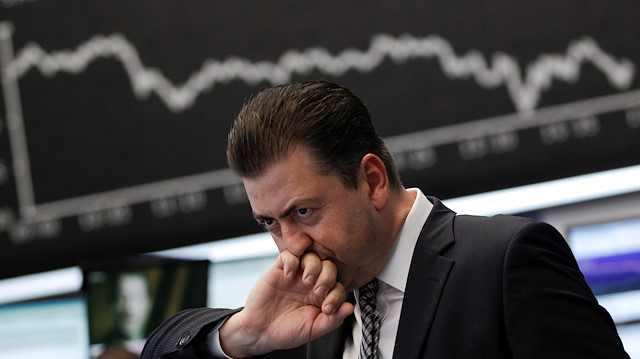 File photo:  A trader reacts at his desk in front of the DAX board at the Frankfurt stock exchange August 18, 2011.