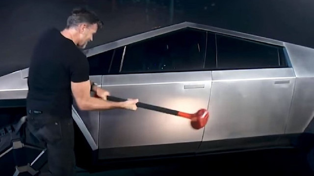 Tesla'nın baş tasarımcısı Franz von Holzhausen elindeki balyozla elektrikli pickup Cybertruck’a vurmaya başladı.