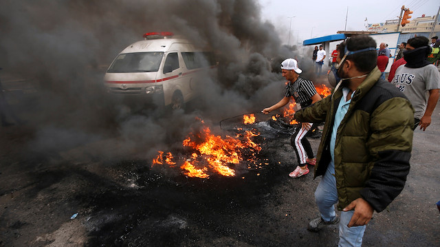 Iraqi protesters burn tires during the ongoing anti-government protests in Basra, Iraq 