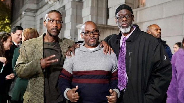 Alfred Chestnut, Andrew Stewart and Ransom Watkins pose for a photo after their release in Baltimore Photograph: Todd Kimmelman/AFP via Getty  