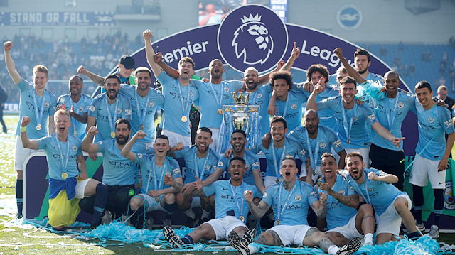 FILE PHOTO: Soccer Football - Premier League - Brighton & Hove Albion v Manchester City - The American Express Community Stadium, Brighton, Britain - May 12, 2019 Manchester City players pose with a trophy 