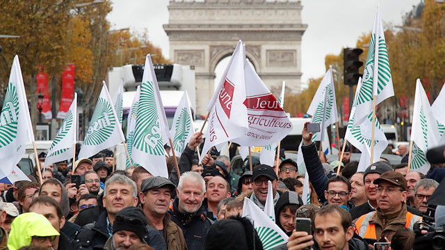 French farmers face block the Champs Elysees avenue in Paris, protesting against low farm incomes and growing criticism of agricultural practices, France