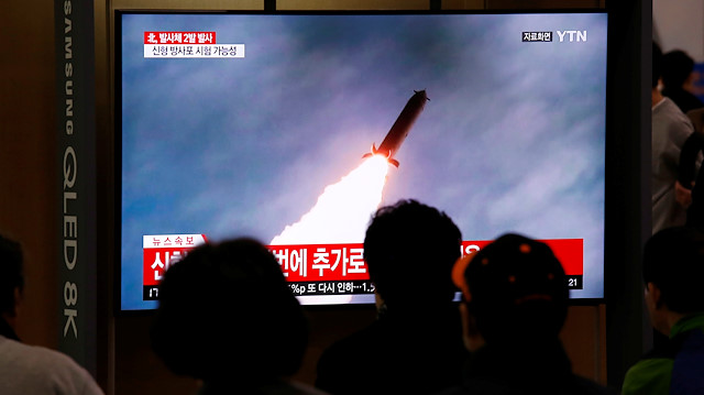 File photo: People watch a TV broadcast showing a file footage for a news report on North Korea firing two projectiles, possibly missiles, into the sea between the Korean peninsula and Japan, in Seoul, South Korea