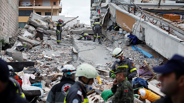 Emergency personnel search for survivors in a collapsed building in Durres