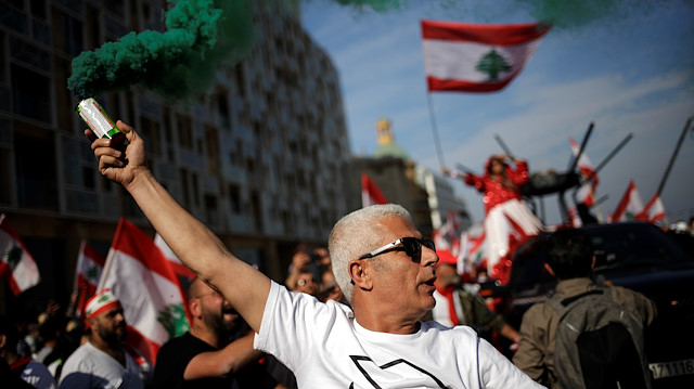 File photo: A man holds up a flare during a protest, on the 76th anniversary of Lebanon's independence in Beirut, Lebanon November 22, 2019