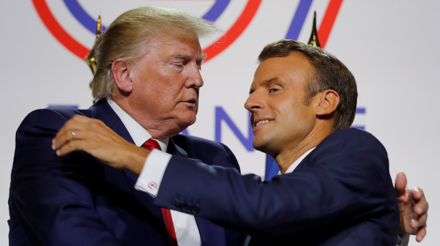 French President Emmanuel Macron greets U.S. President Donald Trump