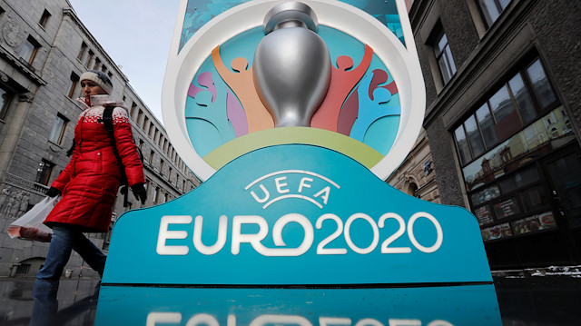 A woman walks past the Euro 2020 