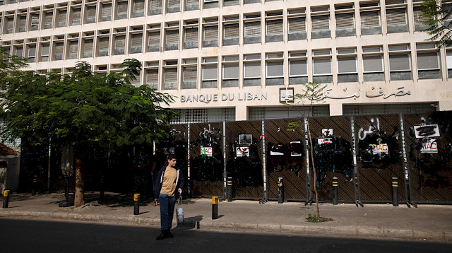 FILE PHOTO: A young demonstrator stands outside the Central Bank of Lebanon in Beirut, Lebanon, October 25, 2019. 
