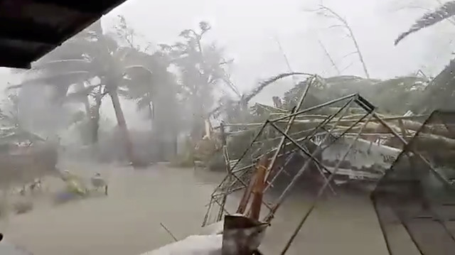 Strong winds and heavy rain batter a flooded landscape as the typhoon Kammuri hits Gloria, Oriental Mindor, Philippines, December 3, 2019 in this still image obtained from a social media video
