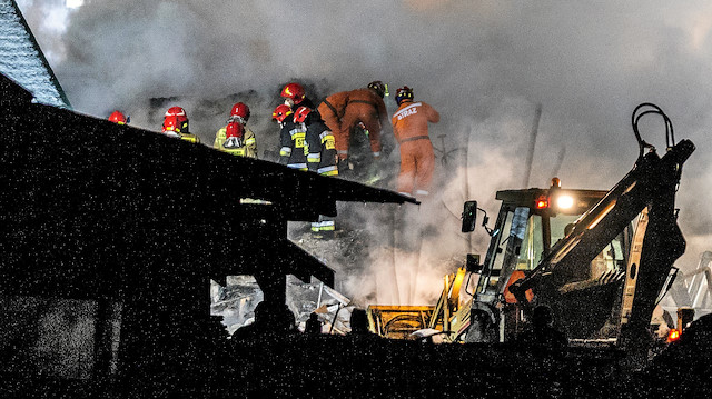 Firefighters work at the site of a building levelled by a gas explosion in Szczyrk, Poland December 4, 2019