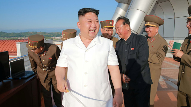 File photo: North Korean leader Kim Jong Un reacts after doing a test-fire of new cruise rocket in this undated photo released by North Korea's Korean Central News Agency (KCNA) 