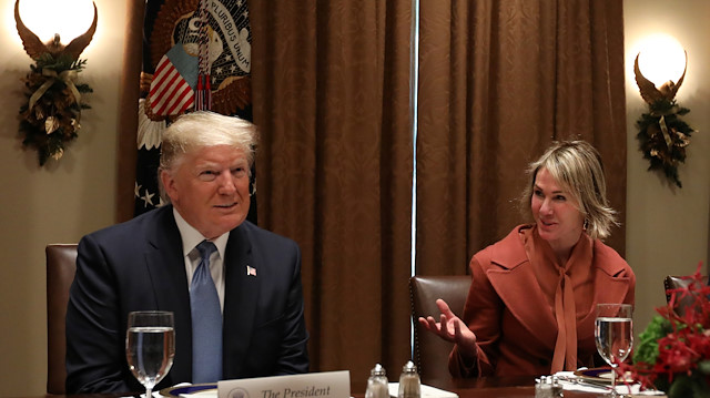 U.S. President Donald Trump, flanked by U.S. Ambassador to the United Nations Kelly Craft and Belgium’s Ambassador to the U.N. Marc Pecsteen de Buytswerve, hosts a lunch for permament representatives to the U.N. Security Council at the White House in Washington, U.S. December 5, 2019.
