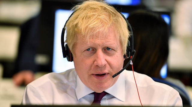 Britain's Prime Minister Boris Johnson speaks to a caller at the Conservative Campaign Headquarters Call Centre in central London, Britain, December 8, 2019. Ben Stansall/Pool via REUTERS

