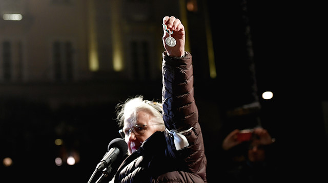 Swedish physician Christina Doctare holds the medal she received while working for the U.N. Peacekeeping force in Bosnia in the 1980s, wanting to return it, as a protest against the awarding of the 2019 Nobel literature prize to Peter Handke during a demonstration in Stockholm, Sweden D