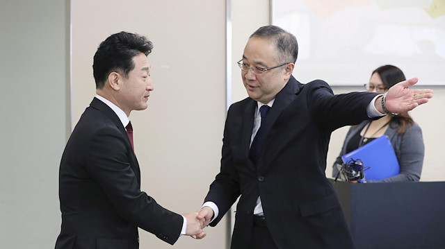 Japan's Director General for Trade Control Department Yoichi Iida shakes hands with South Korea's Director General For International Trade Policy Lee Ho-hyeon shake hands at the start of their senior-level talks in Tokyo, Japan, December 16, 2019, in this photo released by Kyodo