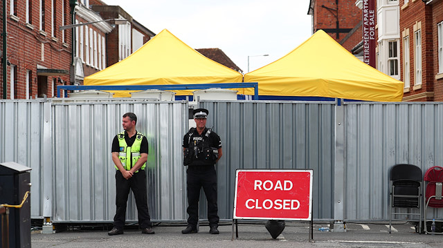 Police officers stand outside the street where Dawn Sturgess lived before dying after being exposed to a Novichok nerve agent, in Salisbury, Britain, July 19, 2018