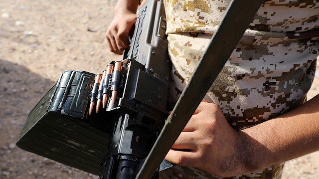 FILE PHOTO: A member of Libya's internationally recognised government forces carries a weapon in Ain Zara, Tripoli, Libya October 14, 2019. REUTERS/Ismail Zitouny/File Photo

