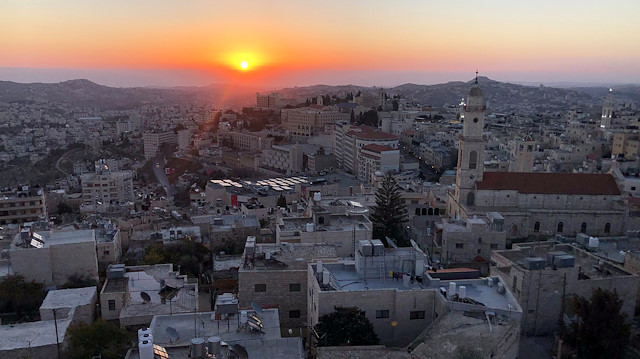 A view shows the sunrise over the city of Bethlehem on Christmas eve