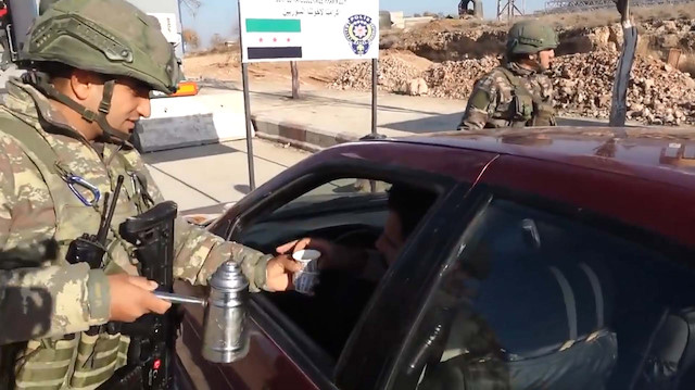 Turkish soldiers offer hot drinks at Syria checkpoints
