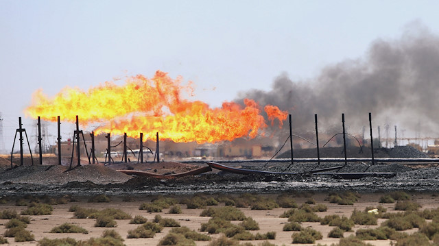 FILE PHOTO: FILE PHOTO: Flames emerge from the flare stacks at the West Qurna-1 oilfield, which is operated by ExxonMobil, near Basra, Iraq June 1, 2019. REUTERS/Essam Al-Sudani/File Photo/File Photo
