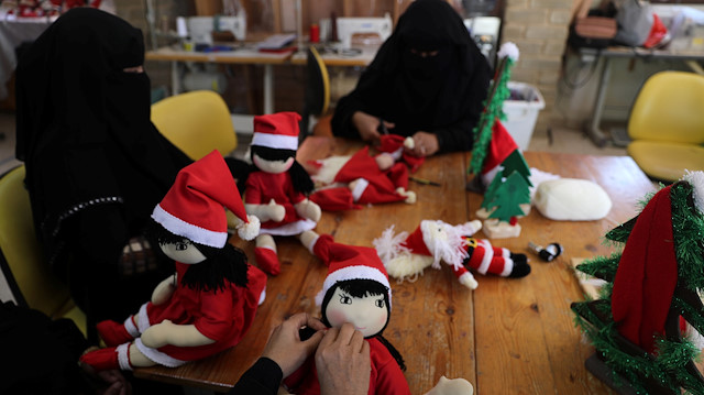 Palestinian women wearing face veil, niqab, make Santa-themed Christmas toys in the northern Gaza Strip December 29, 2019. Picture taken December 29, 2019. REUTERS/Mohammed Salem

