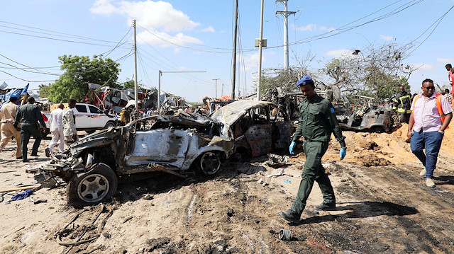 FILE PHOTO: A Somali police officer walks past a wreckage at the scene of a car bomb explosion at a checkpoint in Mogadishu, Somalia December 28, 2019. REUTERS/Feisal Omar/File Photo

