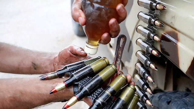 A fighter loyal to Libya's U.N.-backed government (GNA) oils bullets