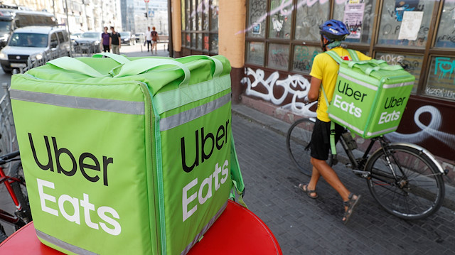 File photo: An Uber Eats food delivery courier pulls a bicycle