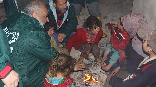 ​İnsan Hak ve Hürriyetleri İnsani Yardım Vakfı Genel Başkanı Bülent Yıldırım, çocuklarla yakılan ateşte ısınmaya çalıştı.