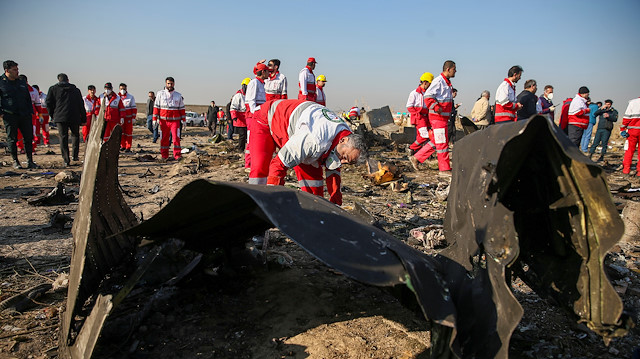 Red Crescent workers check the debris from the Ukraine International Airlines plane, that crashed after take-off from Iran's Imam Khomeini airport, on the outskirts of Tehran, Iran January 8, 2020. Nazanin Tabatabaee/WANA (West Asia News Agency) 