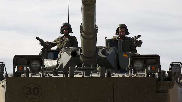Spanish troops drive a Cougar armored reconnaissance vehicle 