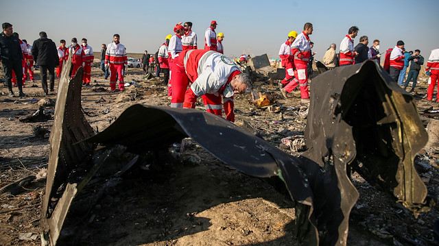File phto: Red Crescent workers check the debris from the Ukraine International Airlines plane, that crashed after take-off from Iran's Imam Khomeini airport, on the outskirts of Tehran, Iran January 8, 2020