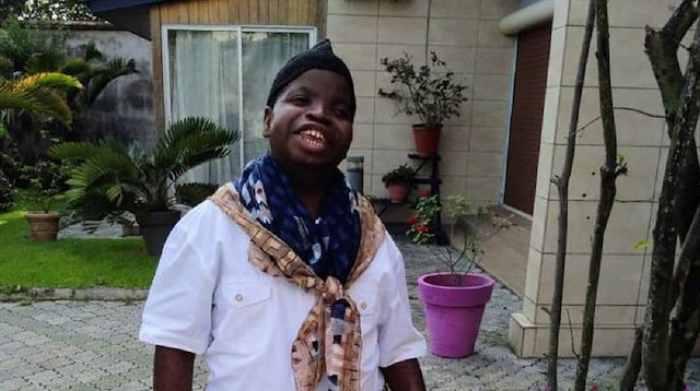 Eric Bile Massouke, 30 Years old autistic poses for a photo.