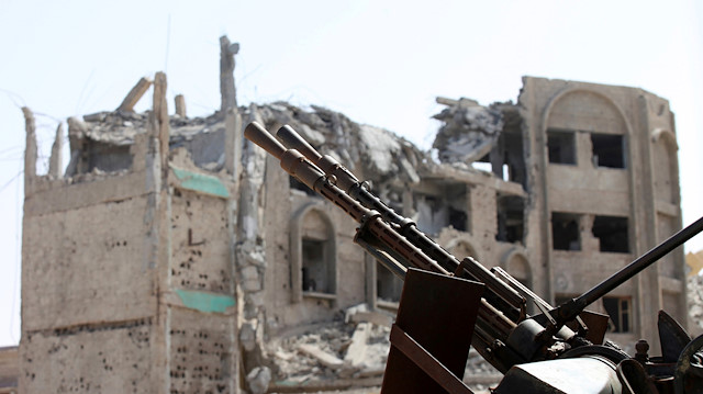 File photo: A weapon is seen in front of a building that was destroyed during a battle in Libya