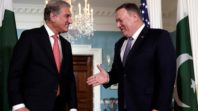 U.S. Secretary of State Mike Pompeo (R) shakes hanse with Pakistani Foreign Minister Makhdoom Shah Mahmood Qureshi