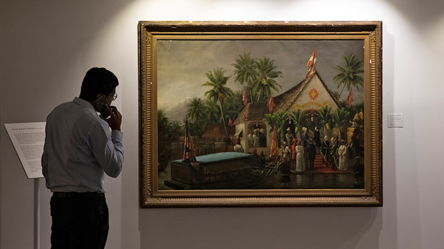File photo: A staff member speaks on his phone as artworks once part of billionaire jeweller Nirav Modi's collection are seen on display ahead of their auction at a gallery in Mumbai, India, March 25, 2019