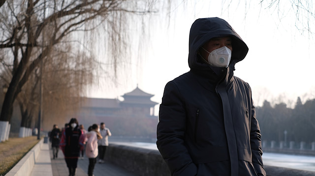 File photo: People wearing protective masks walk outside Forbidden City which is closed to visitors, according to a notice in its main entrance for the safety concern following the outbreak of a new coronavirus, in Beijing, China January 25, 2020