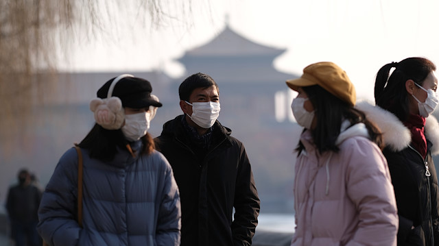 File photo: People wearing protective masks walk outside Forbidden City which is closed to visitors, according to a notice in its main entrance for the safety concern following the outbreak of a new coronavirus, in Beijing, China January 25, 2020. 