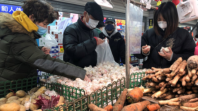 People wearing face masks select vegetables at a supermarket, as the country is hit by an outbreak of the new coronavirus, in Beijing, China January 26, 2020. REUTERS/Carlos Garcia Rawlins

