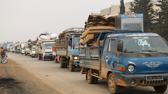  Trucks carry belongings of people fleeing from Maarat al-Numan