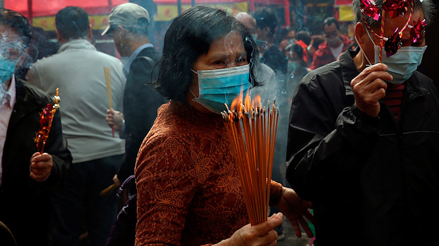 Worshippers wear masks to prevent an outbreak of a new coronavirus 