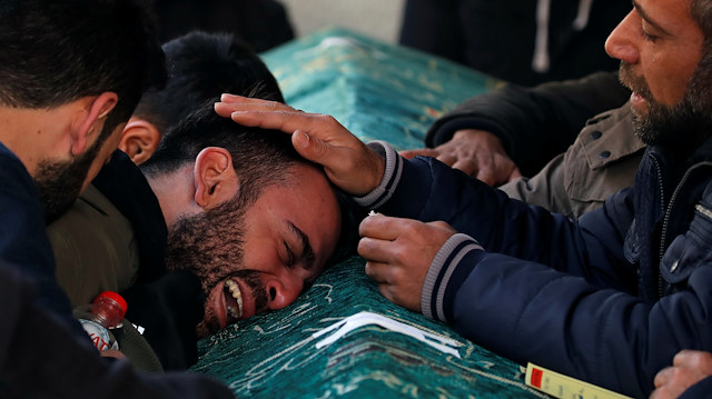 A man grieves during a funeral for earthquake victims in Elazig, Turkey,